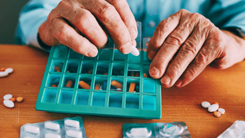 Filling up a pill box with multiple medications