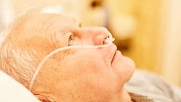 Sick senior with oxygen tube
